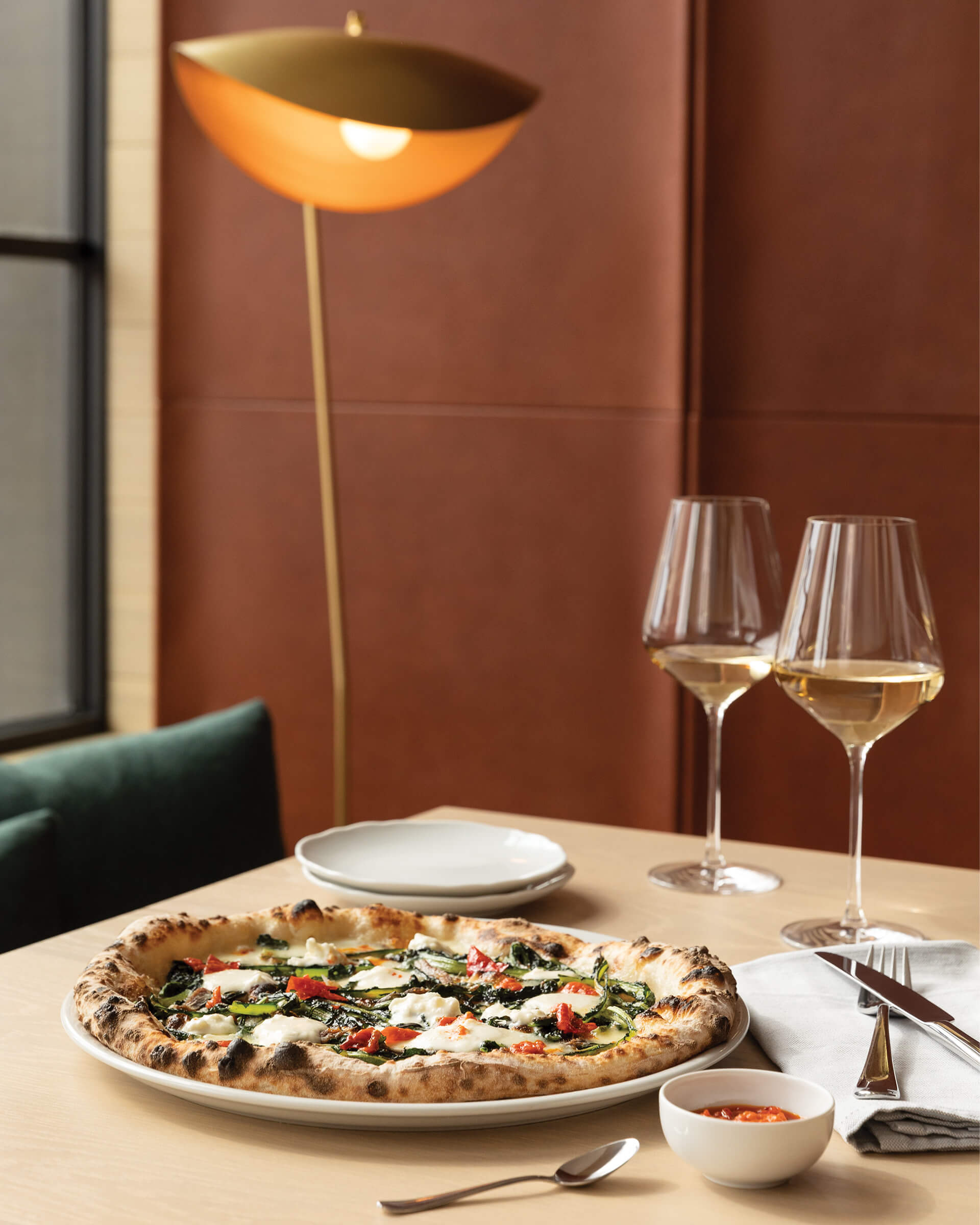 pizza on table with wine glasse