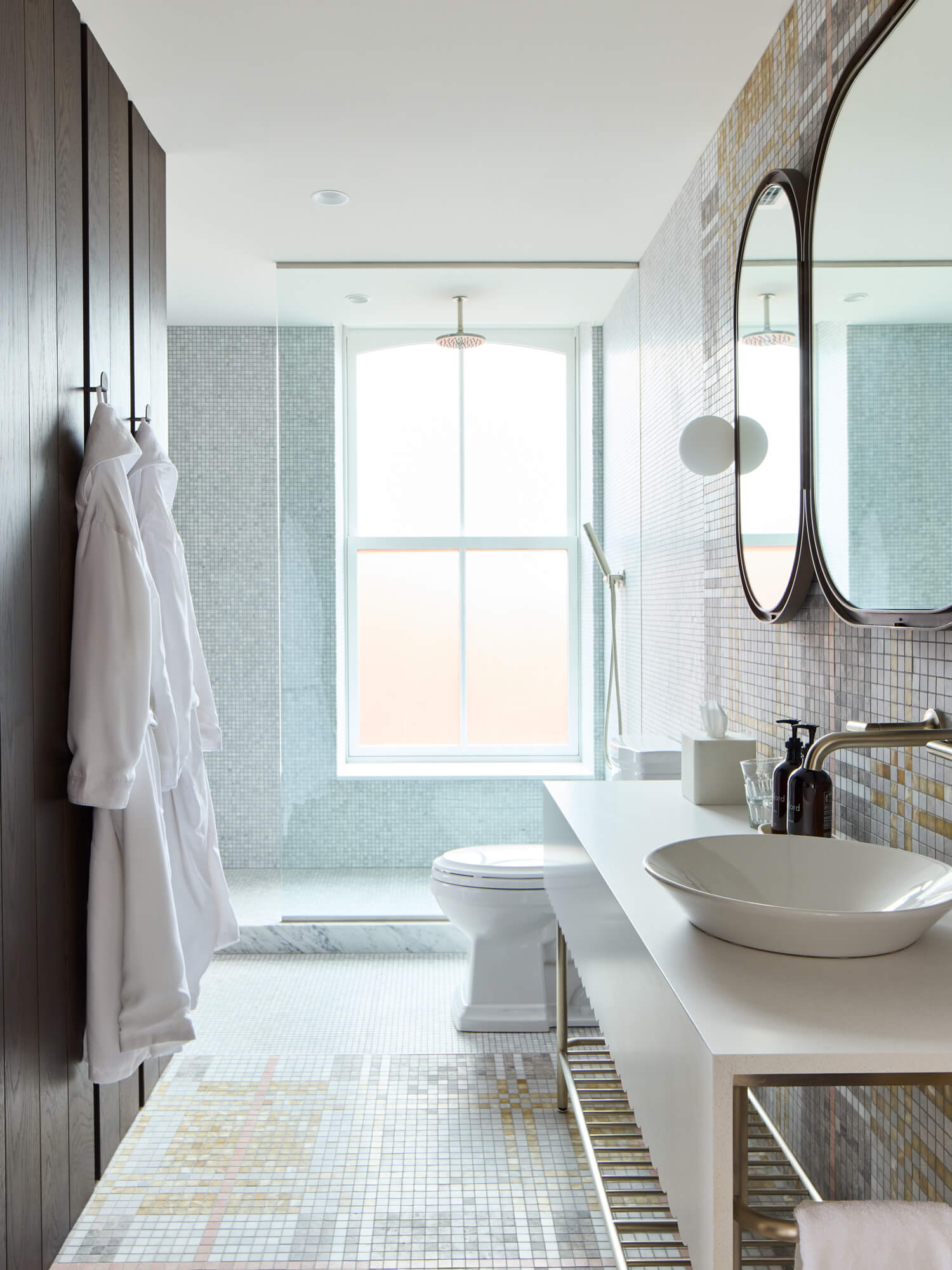 A spacious bathroom with a large shower and blue tones