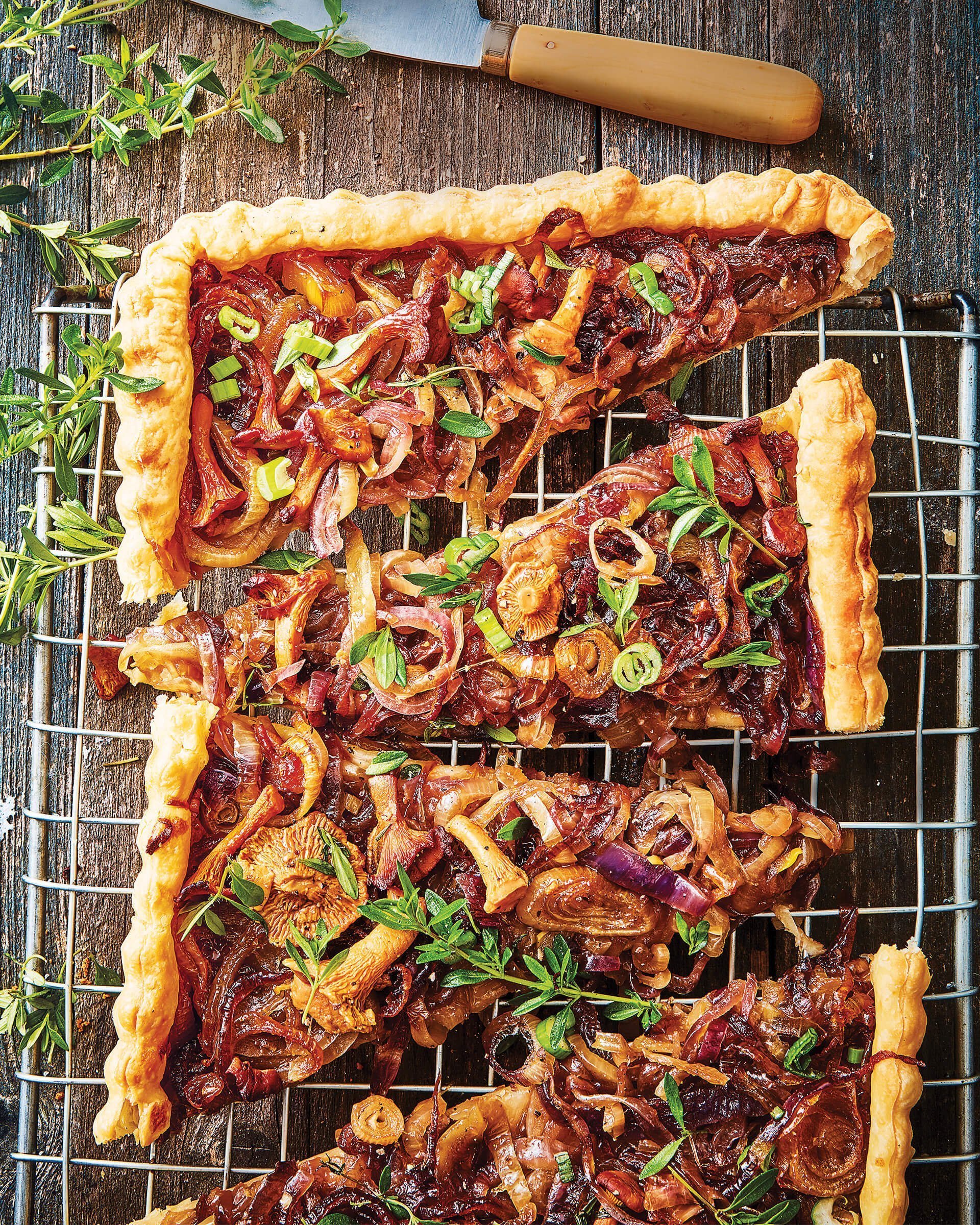 A sliced tart with onions and thyme.
