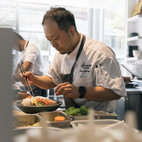 Masayoshi prepares sashimi in a kitchen.