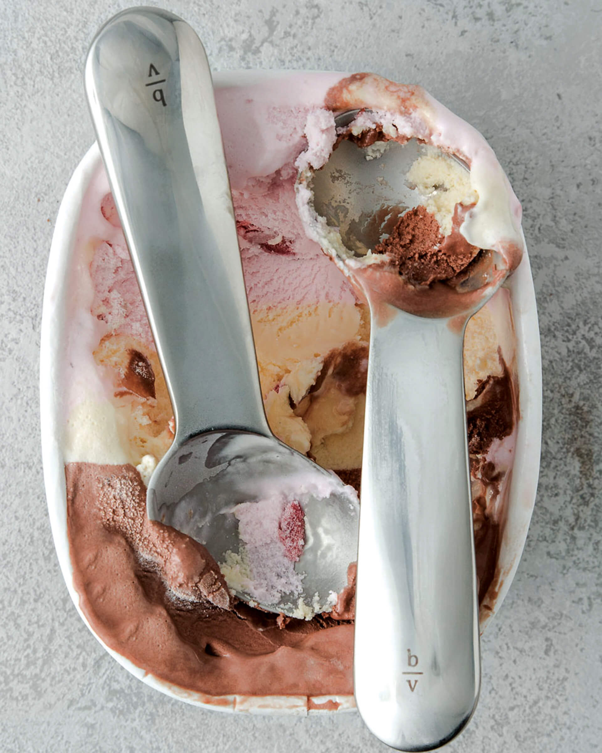 two ice cream scoops in container of ice cream