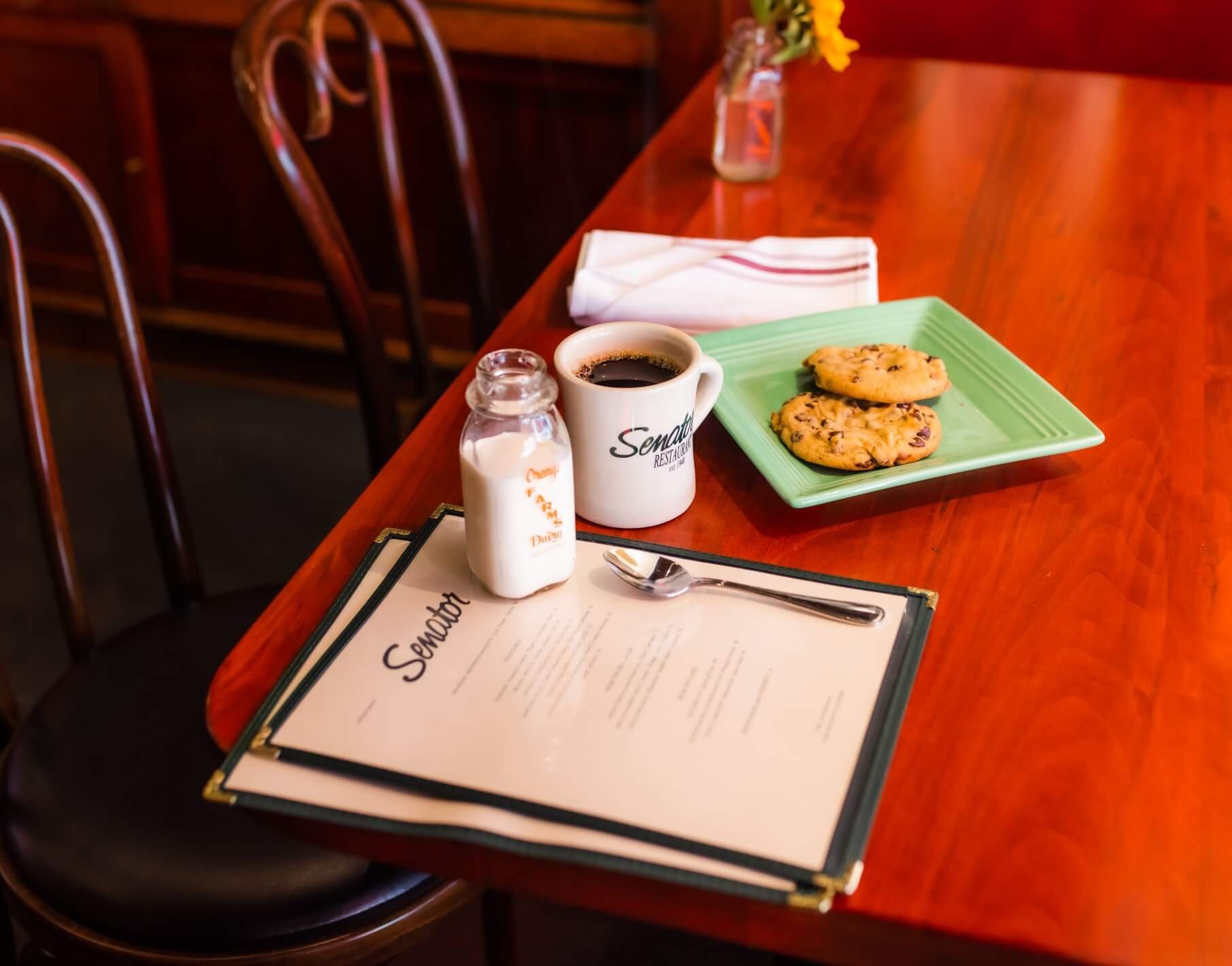 table with menu coffee cup and cookies
