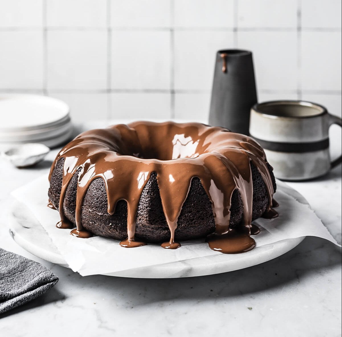A bundt cake with chocolate drizzled over the top
