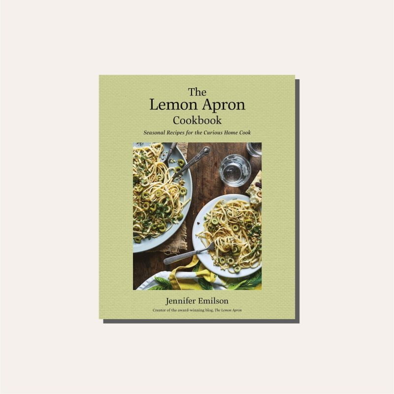 A green cookbook on a cream background