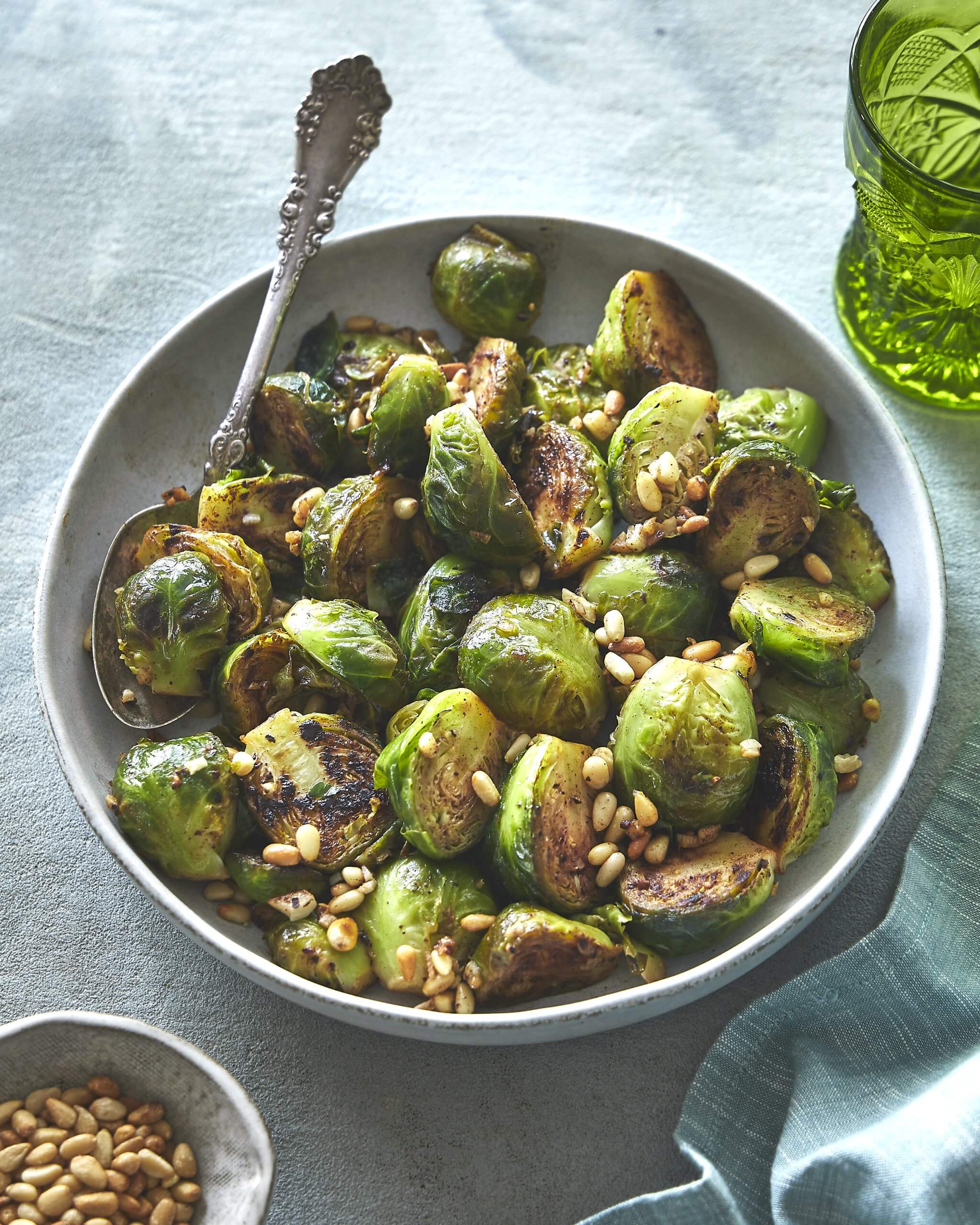 A bowl of Brussels sprouts with a spoon