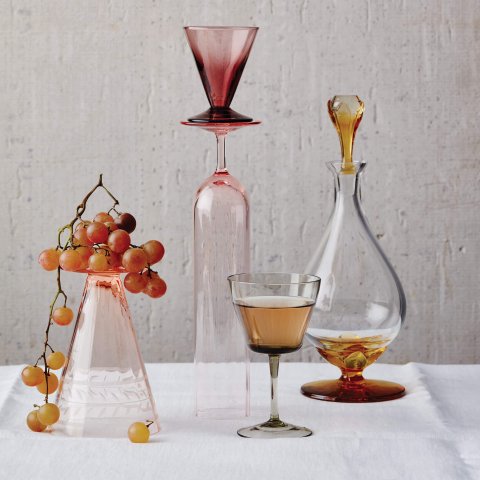 Decanters and wine glasses with a bunch of grapes