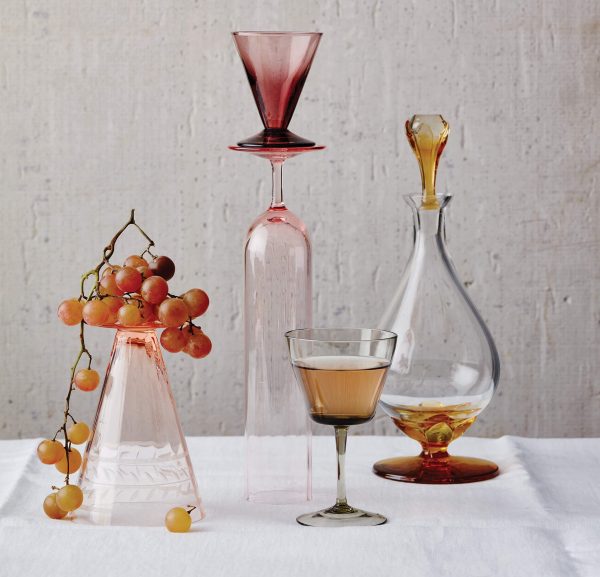 Decanters and wine glasses with a bunch of grapes