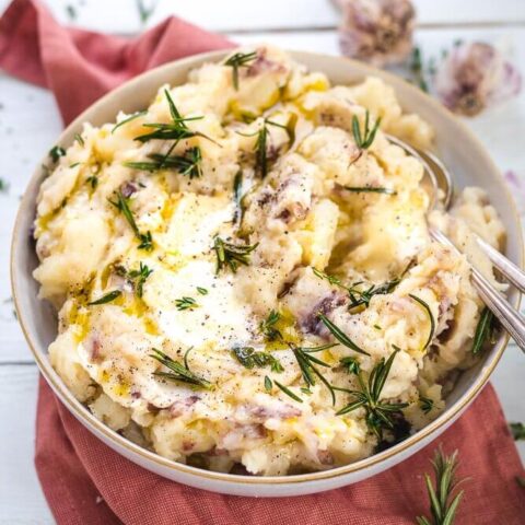 A bowl of mashed potatoes on a red cloth