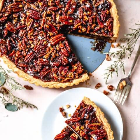 A pecan pie with a slice out of it
