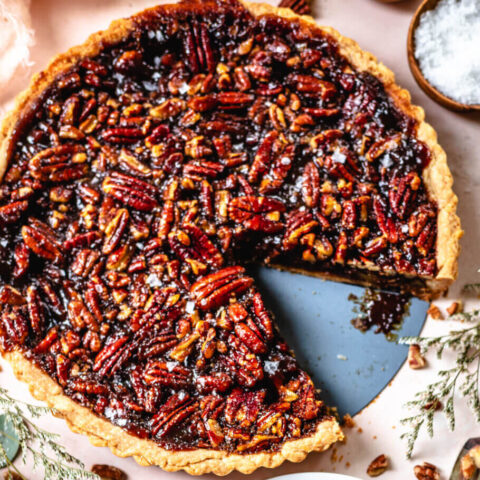 A pecan pie with a slice out of it