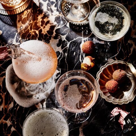 A black marble surface with glasses of champagne