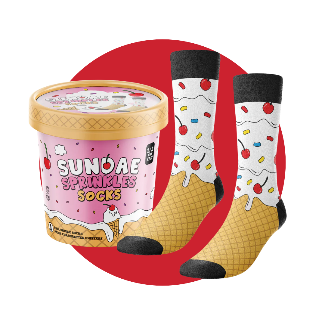A pink ice cream carton and a pair of socks patterned to look an ice cream sundae on a decorative red circle. 