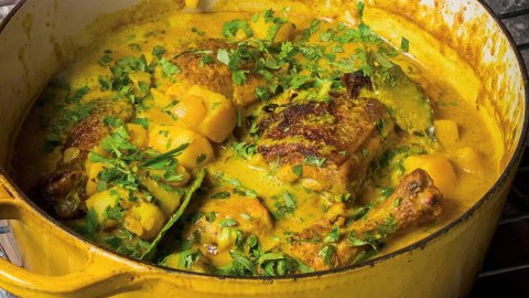 A yellow pot with a Jamaican recipe for curry chicken