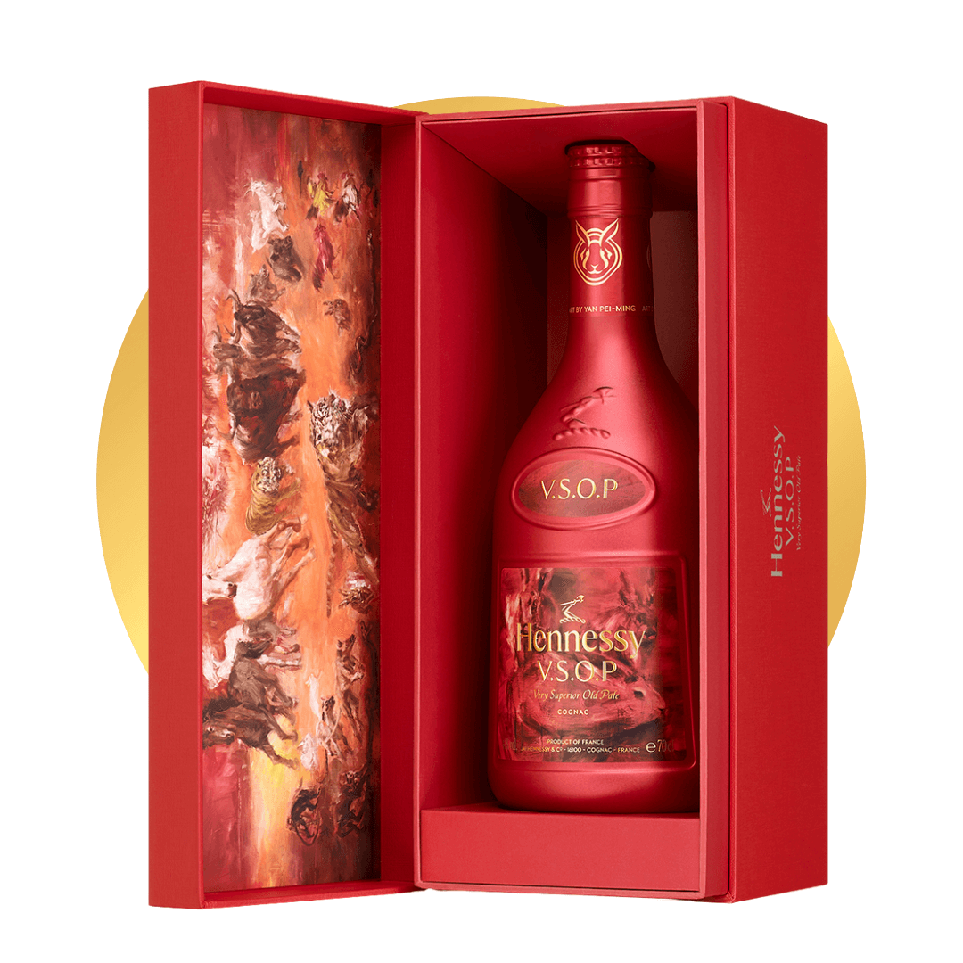 An open red gift box with a bottle of Hennessy on a gold circle.