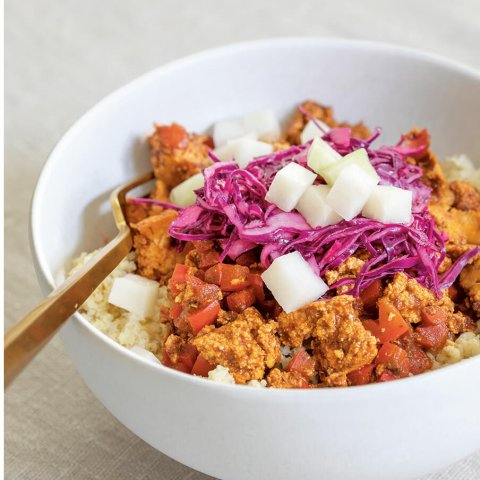 A white bowl with tofu sofrito and red cabbage.