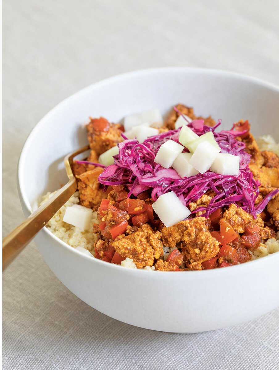 A white bowl with tofu sofrito and red cabbage.