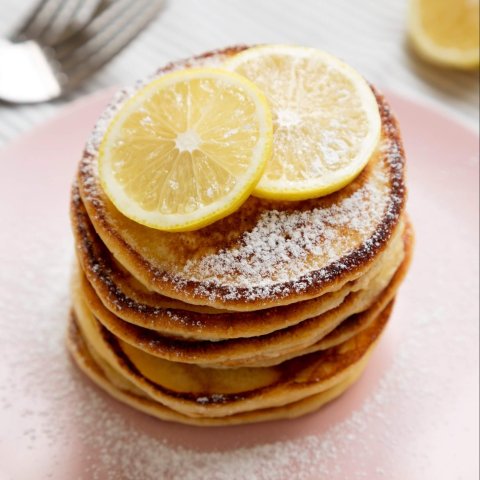 stack of pancakes with lemons on top