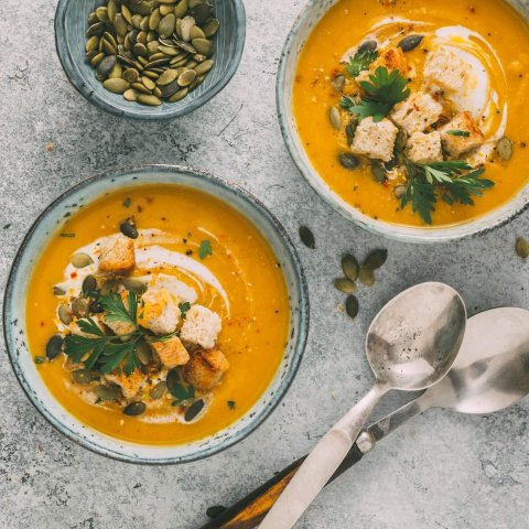 Pumpkin Soup with with croutons and pumpkin seeds, Top view.