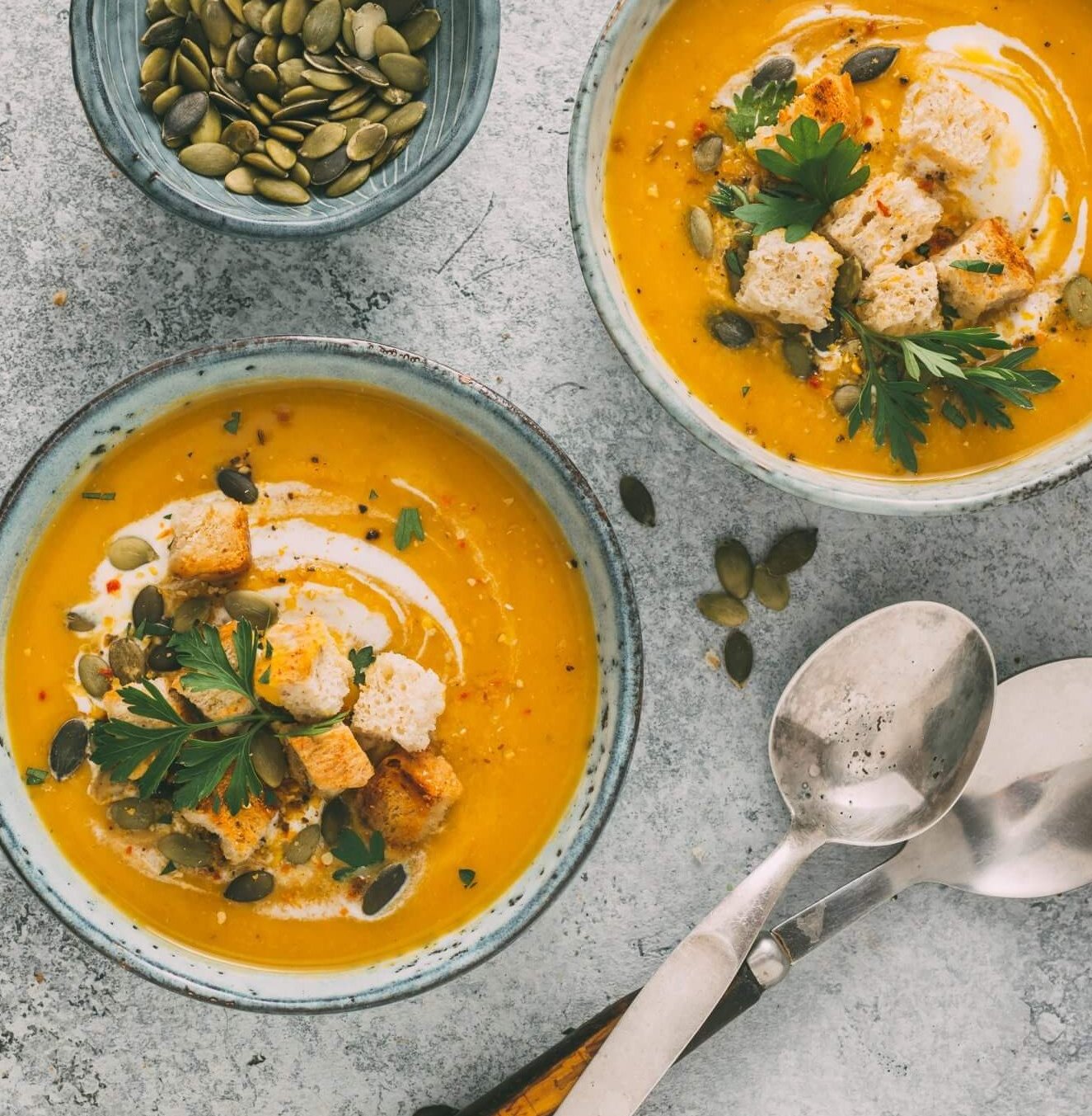 Pumpkin Soup with with croutons and pumpkin seeds, Top view.