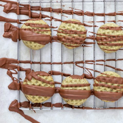 A baking sheet with cookies drizzled in chocolate.