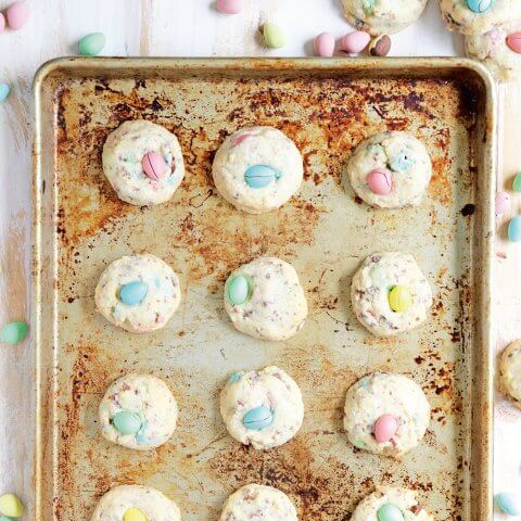 A baking tray with shortbread cookies and mini chocolate eggs.