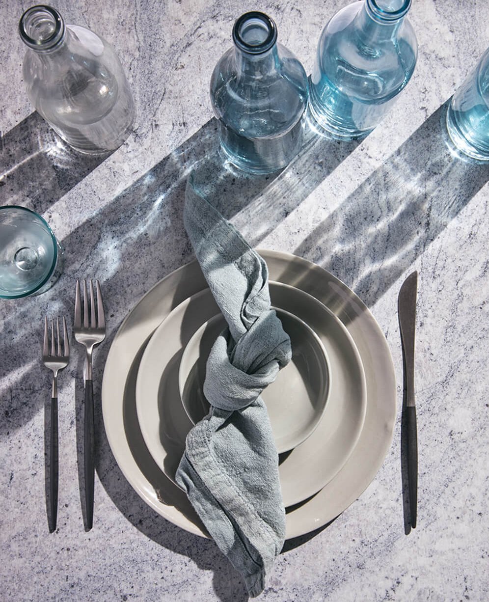 grey plates sitting on a table