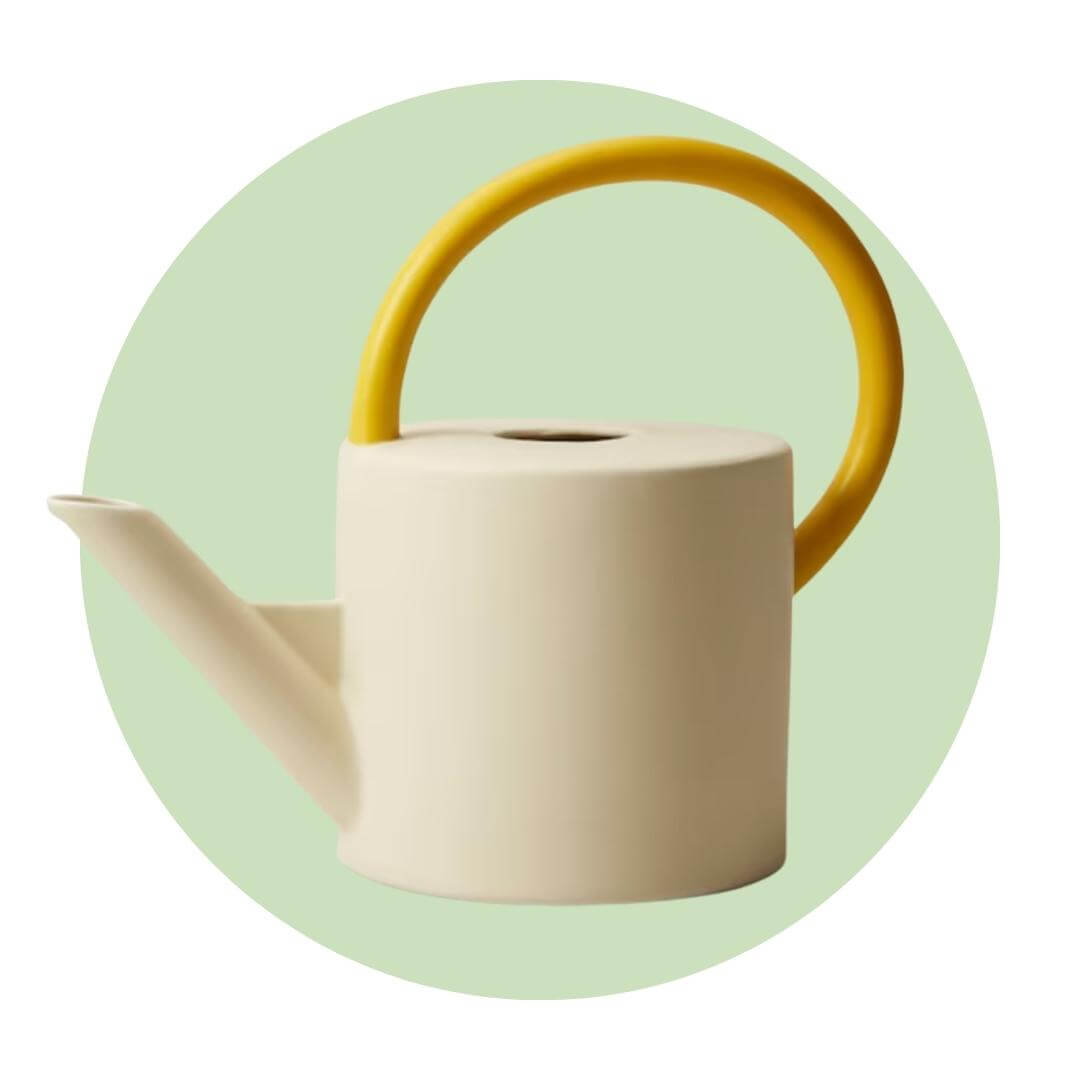A light watering can with a yellow handle on a light green circle