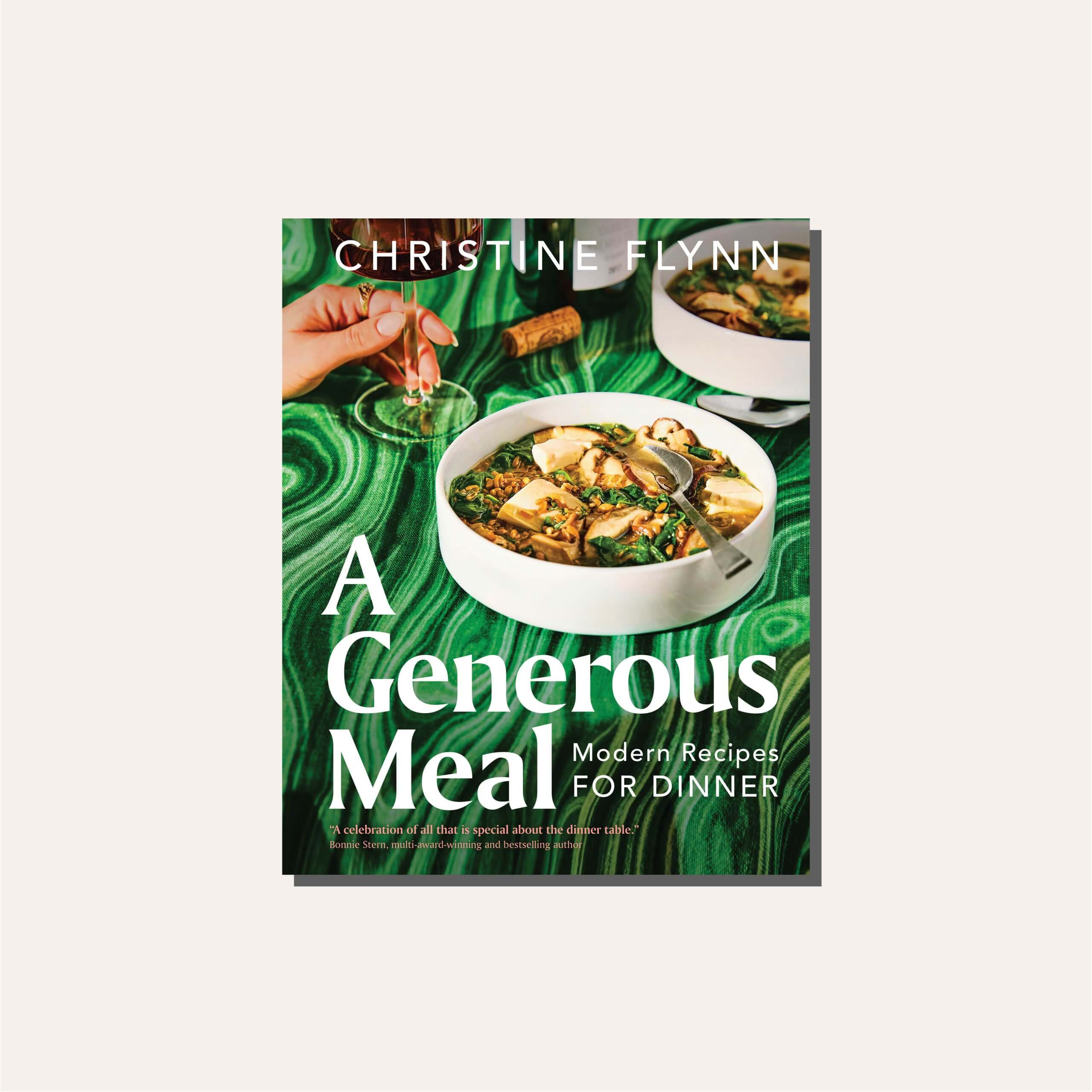 A deep green cookbook cover in a light tan frame