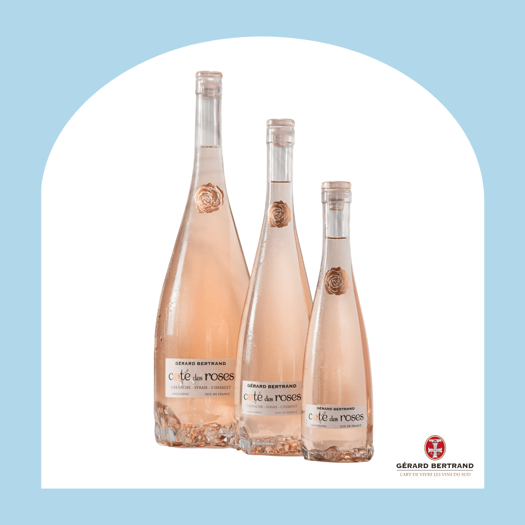 Three bottles of rose wine in descending sizes in a light blue arch frame