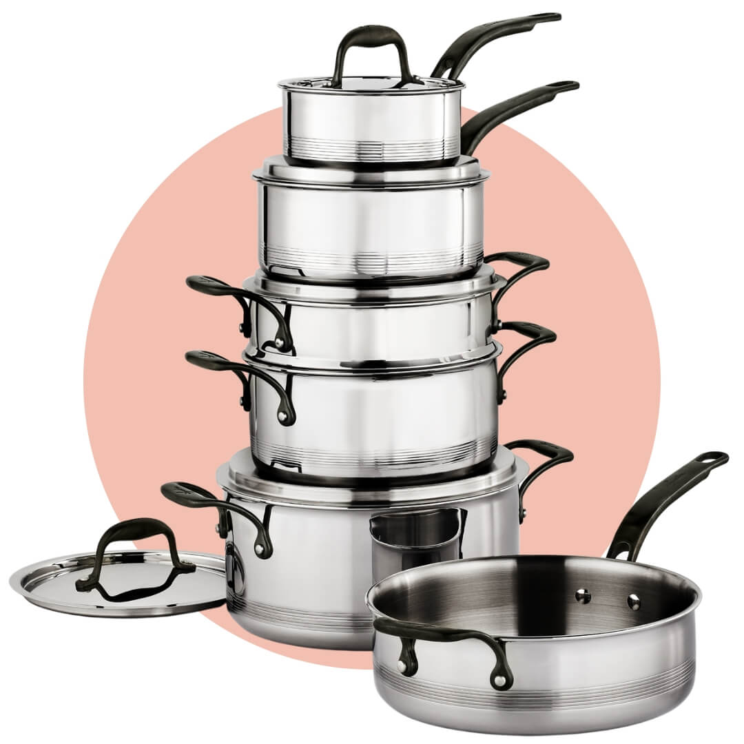A silver and black cookware set on a light pink circle graphic