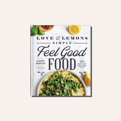A white and green cookbook cover in a tan frame for Jeanine Donofrio's Feel Good Food Love and Lemons