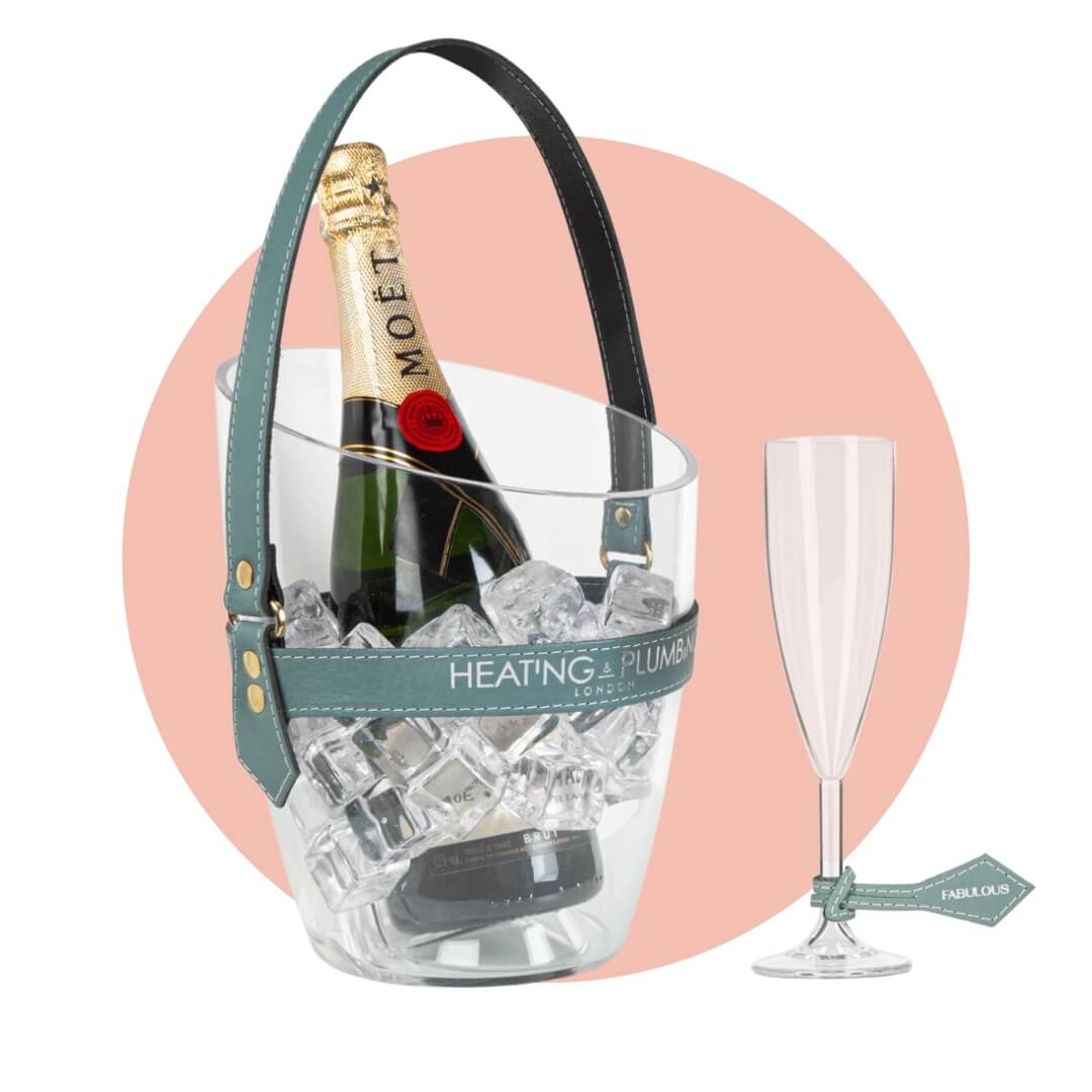 A champagne bucket with a bottle of Moët and a flute with a tag on the stem on a light blue circle graphic