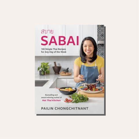 A cookbook cover in a light frame with a portrait od Canadian food Personality Pailin Chongchitnant