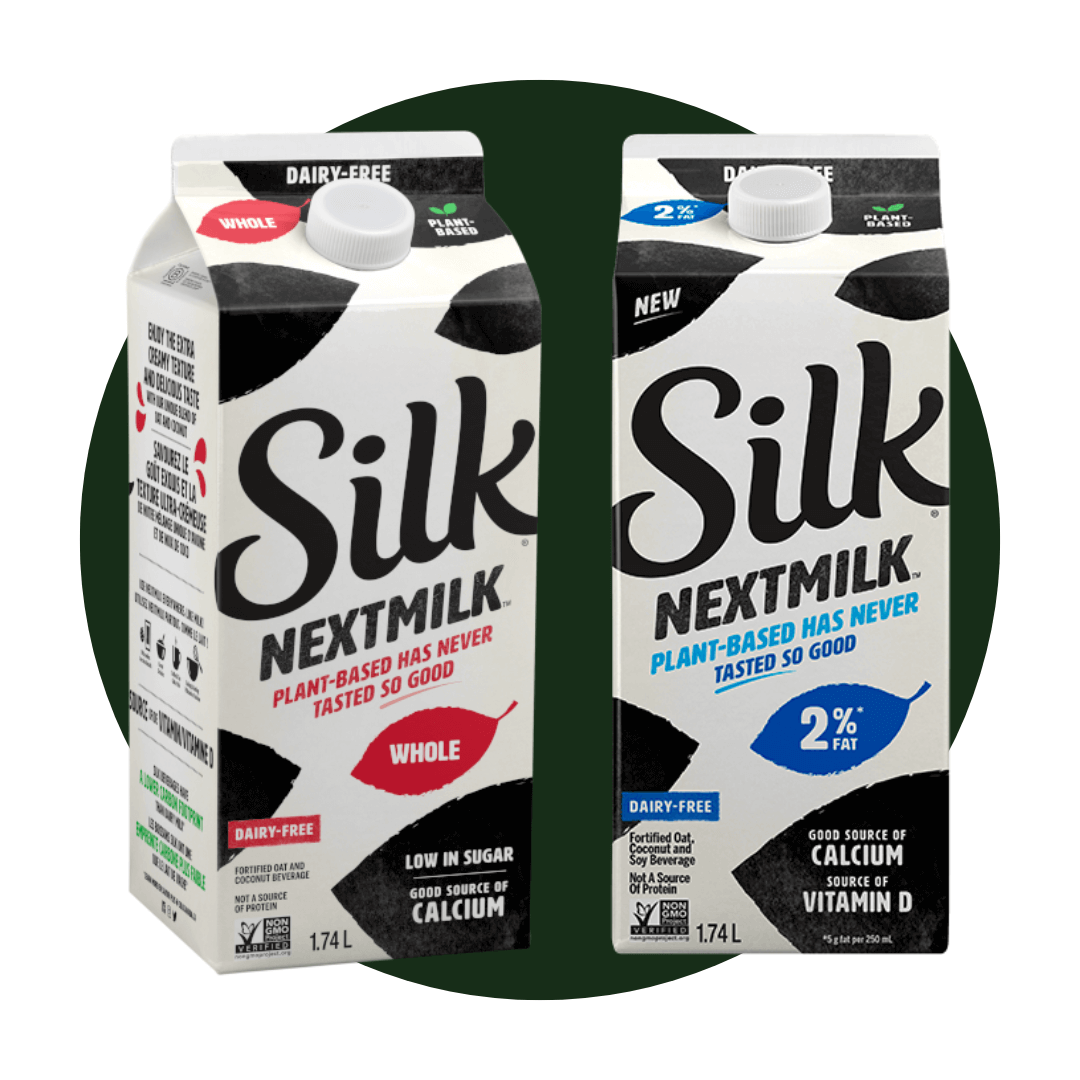 Two cartons of milk on a dark green circle