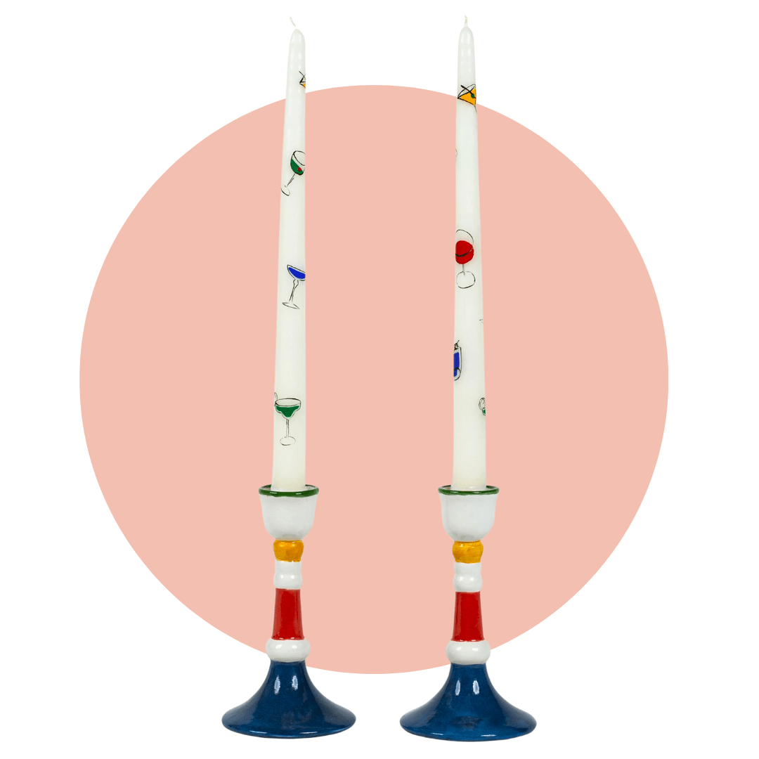 Two taper candles in holders