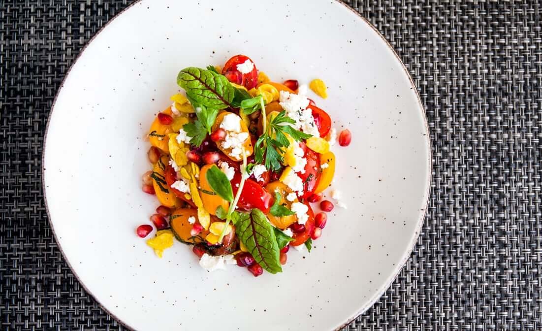A colourful salad on a white plate 