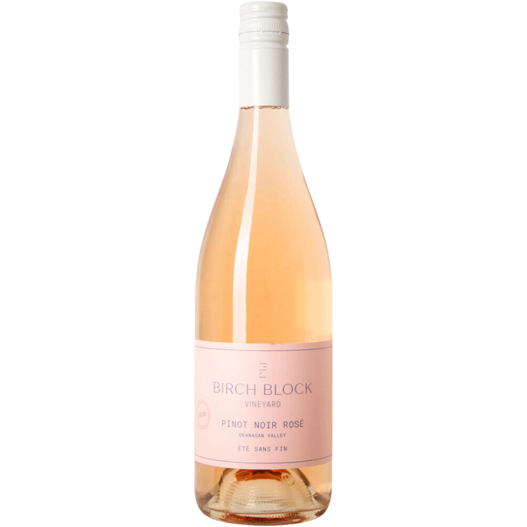 A bottle of pale rose wine with a pink label and white cap