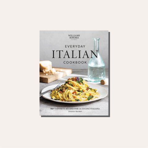 A cookbook cover with a plate of pasta on it in a light tan frame