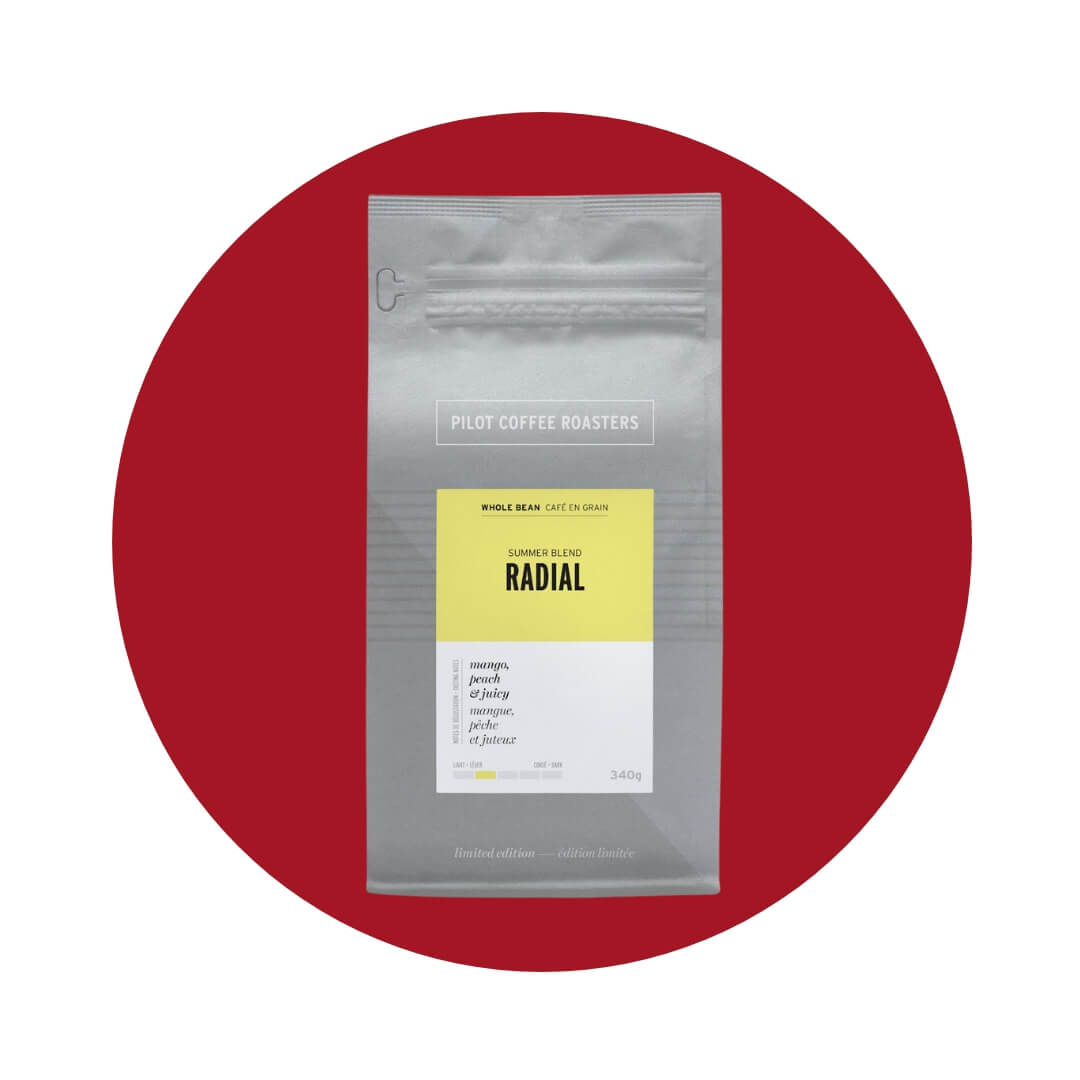 A silver bag with a yellow and white label on a red circle graphic.