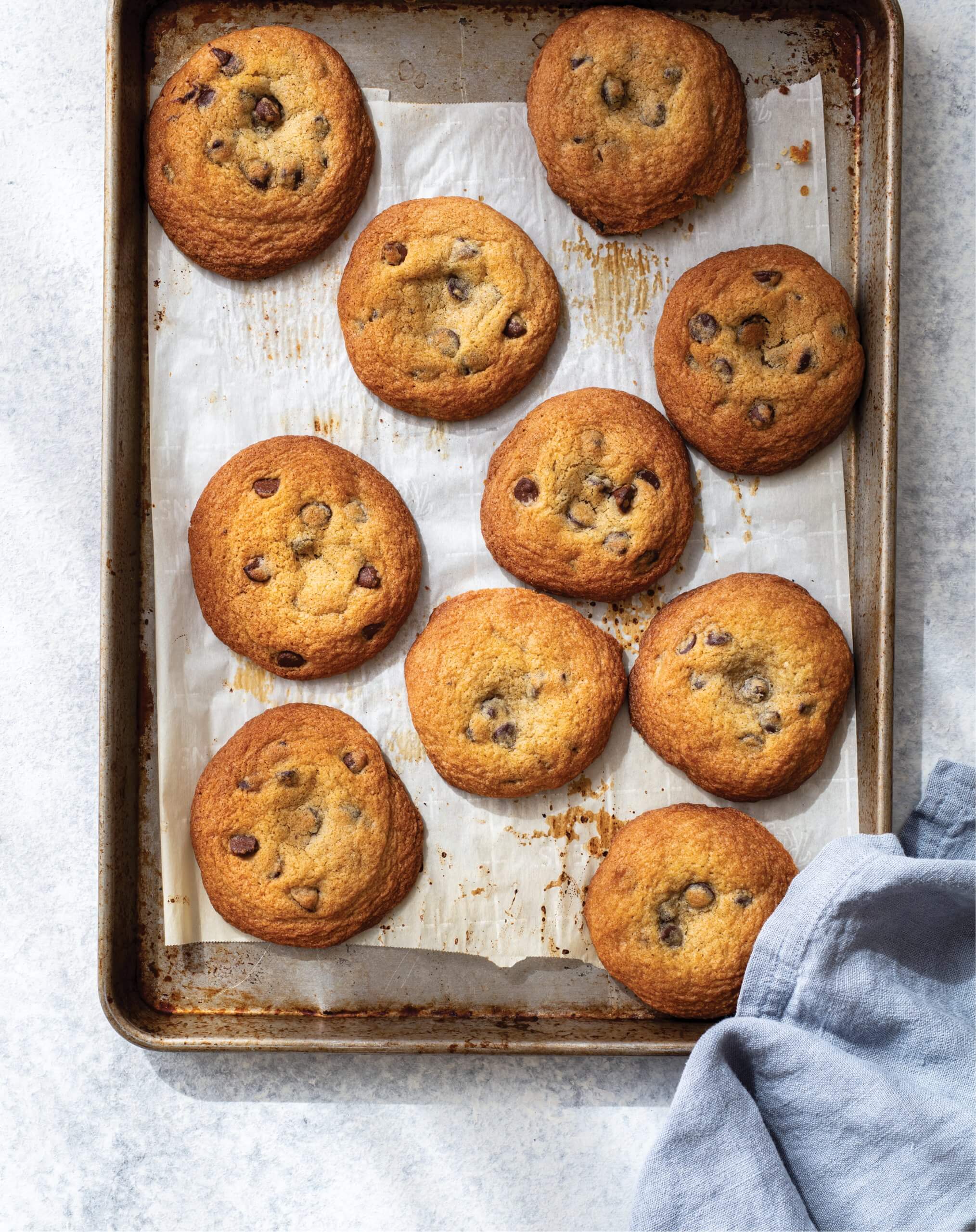 A silver baking sheet with chocolate chip cookies