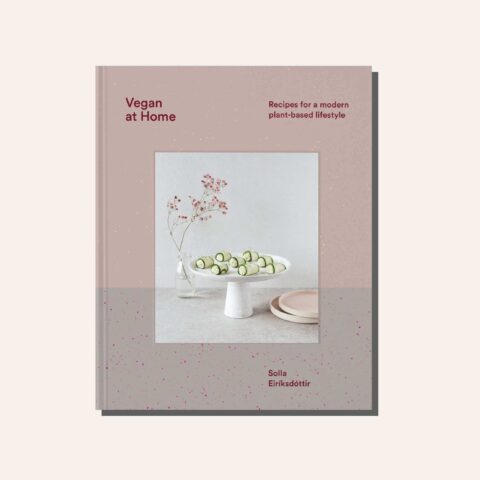 A light pink and grey cookbook cover in a tan frame