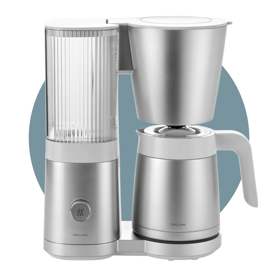 A silver drip coffee maker on a blue circle graphic.