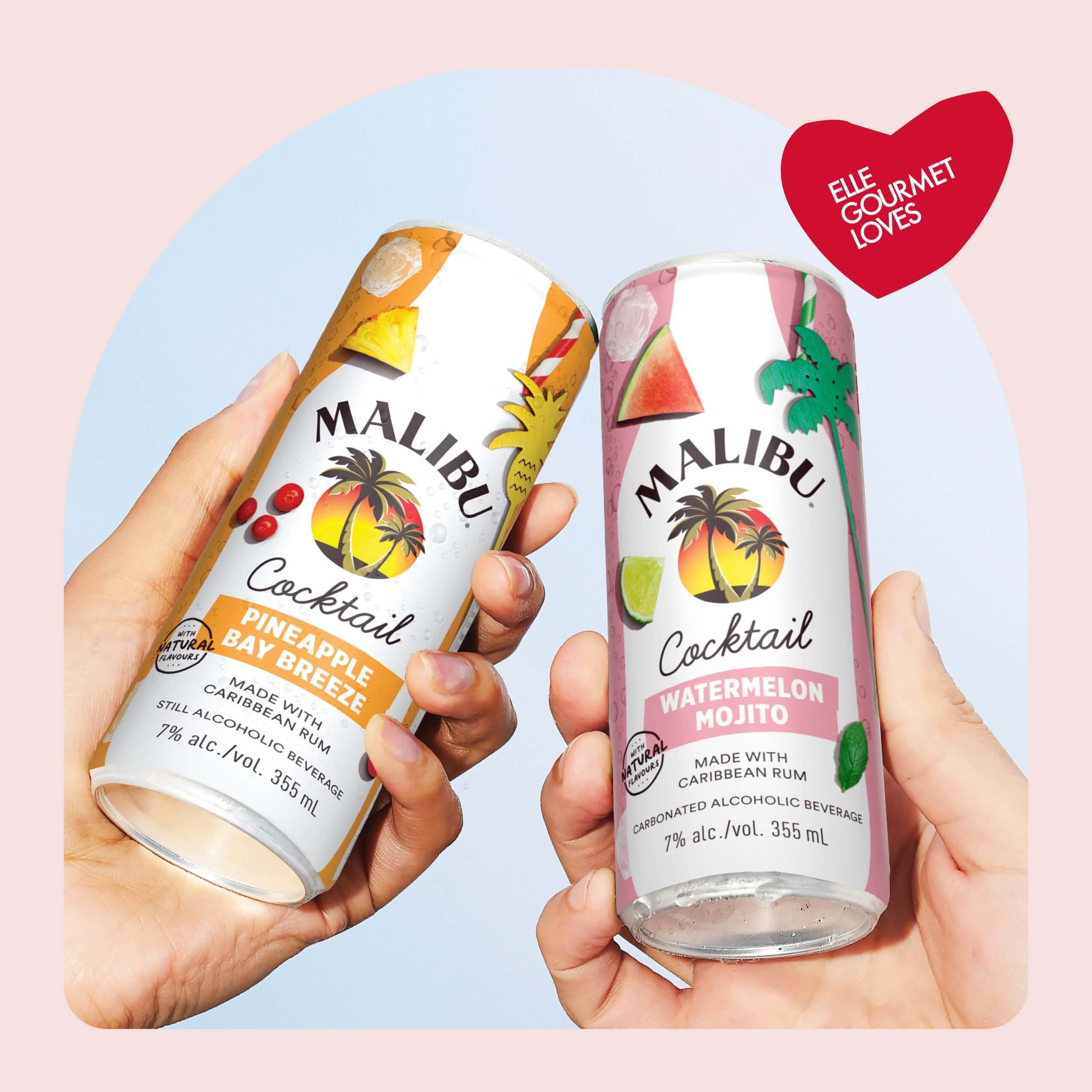 Two hands holding canned cocktails against the sky, in a light pink frame with a heart bearing the words "ELLE Gourmet Loves"