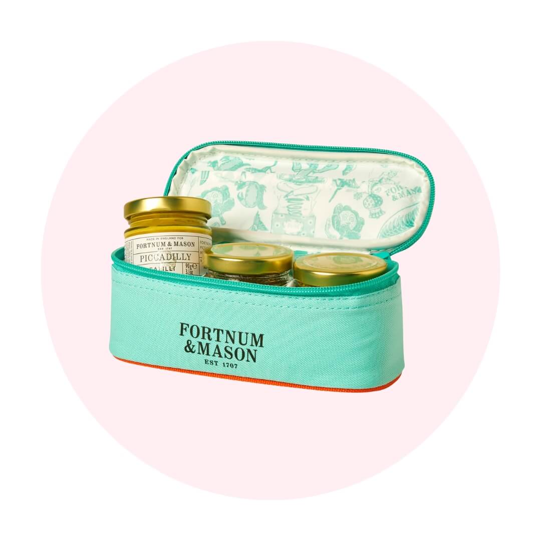 A blue pouch with three jars on a light pink circle graphic