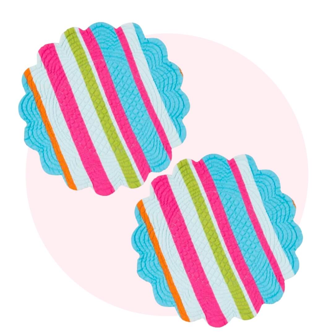 Blue, pink, orange, white and green striped placemats in a round shape with wavy edges over a light pink circle graphic