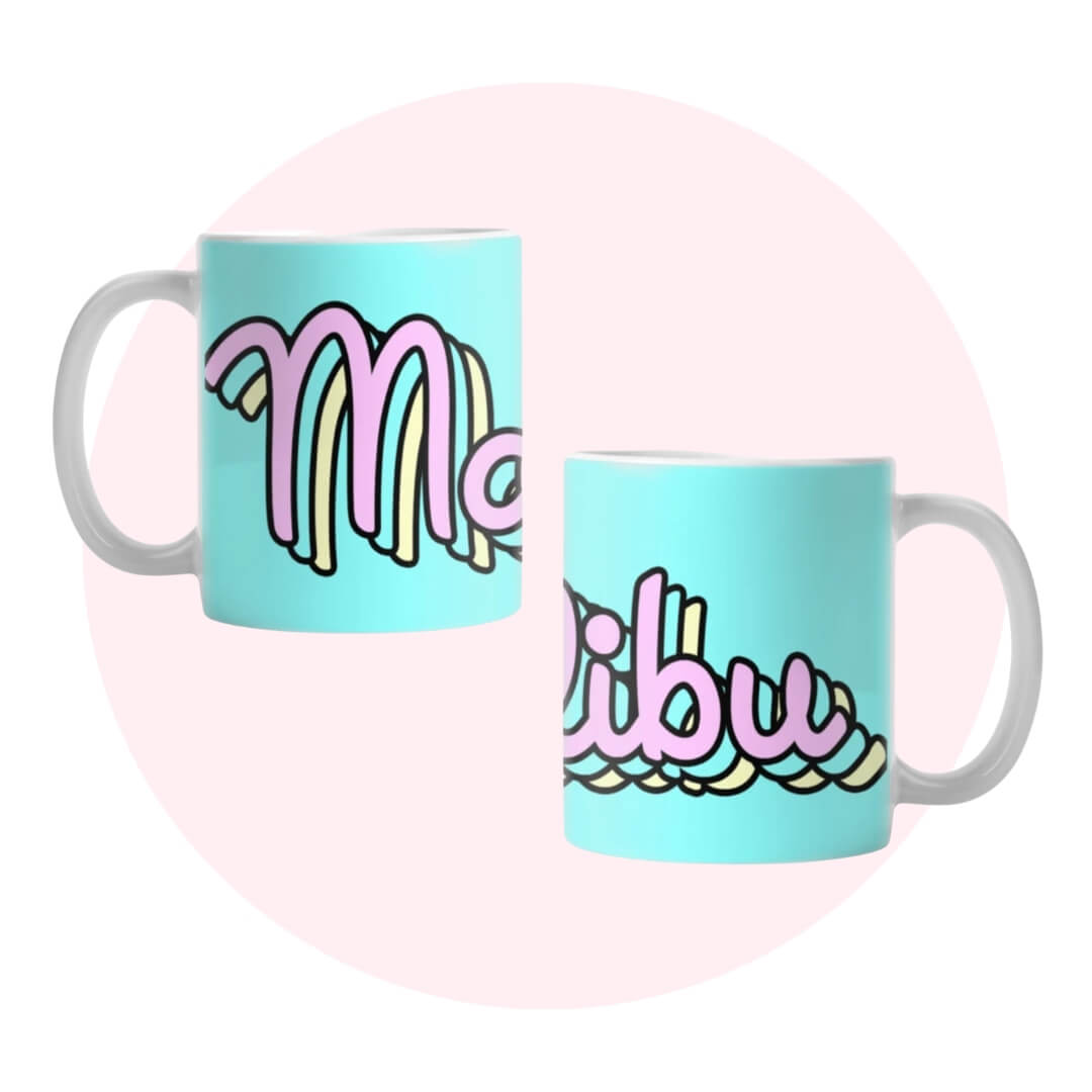 Two angles of a blue mug with the world "Malibu" written in cursive around it on a light pink circle graphic