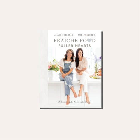 A white and grey cookbook cover in a light tan frame