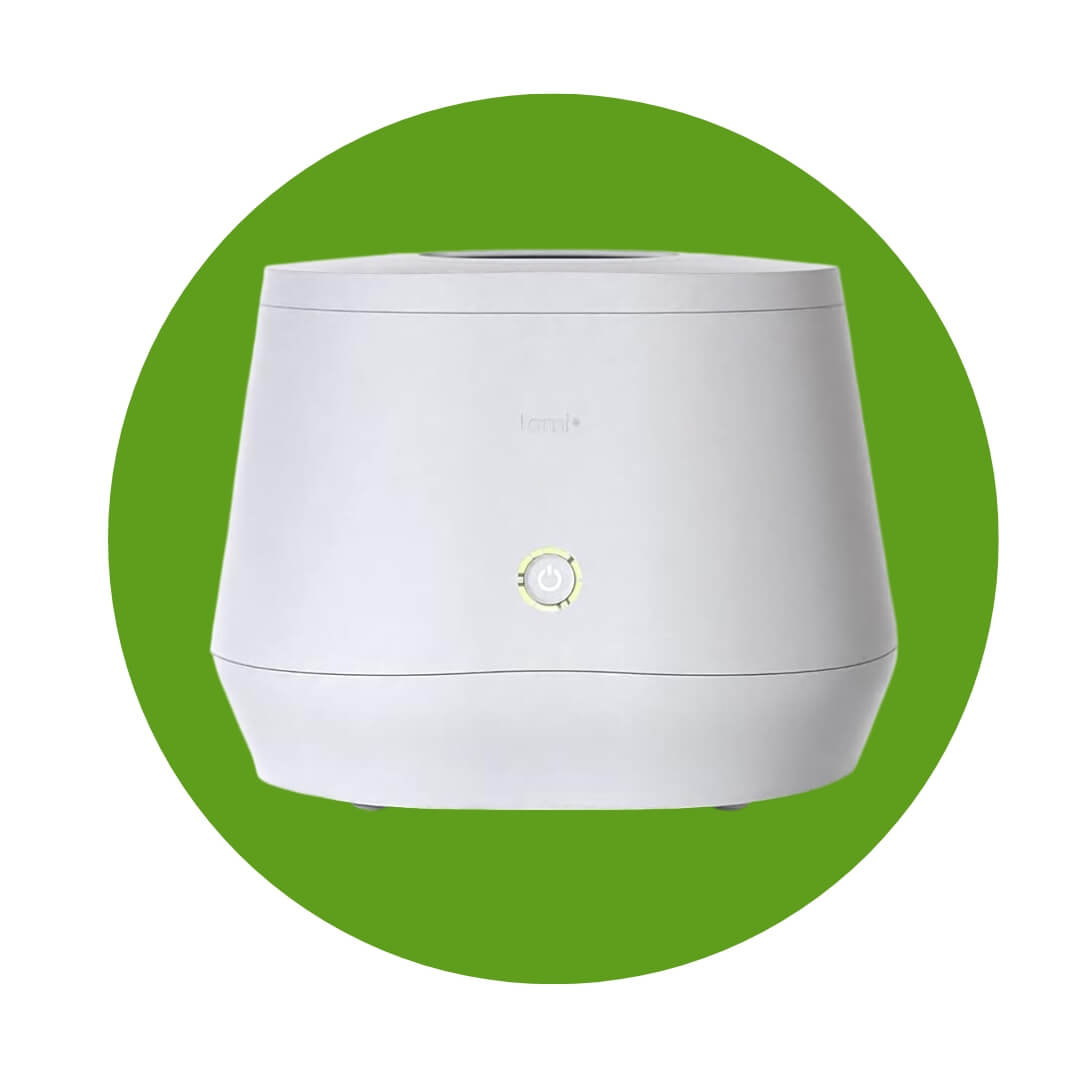 A white compact composter over a green circle graphic
