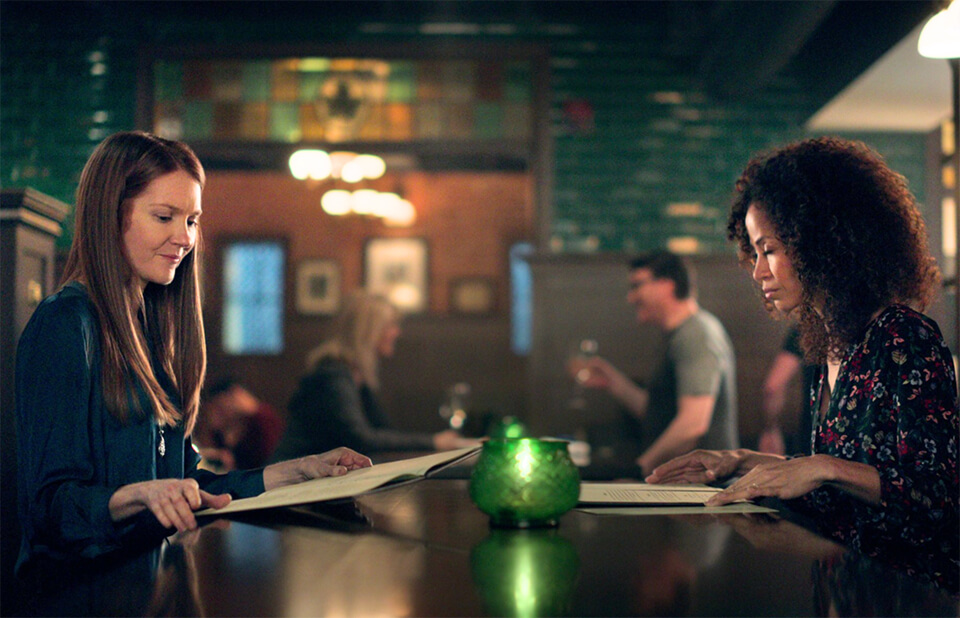 Two women looking at menus at a restaurant