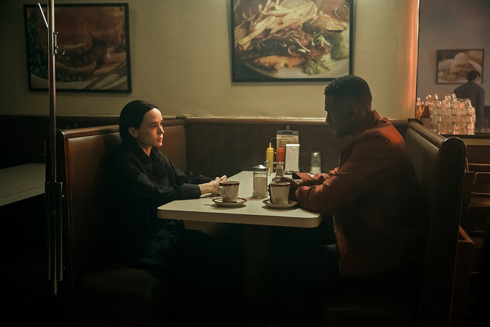 Two men sitting at a diner booth